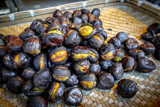 Roasted chestnuts on the street. Street food. Fried chestnuts.