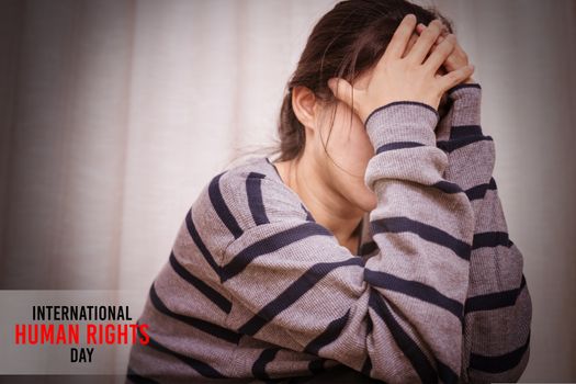 International Human Rights Day Concept, depressed women sitting in the dark room, alone, sadness, emotional concept