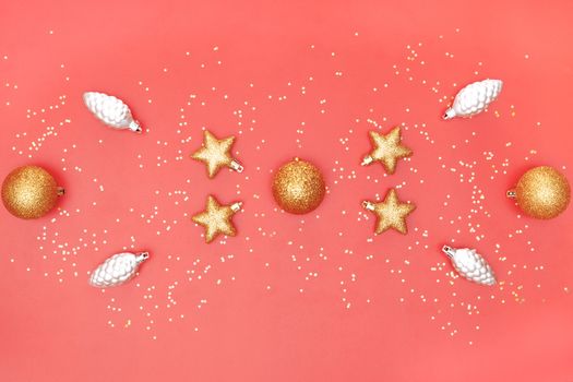golden ball, star and bell on pink living coral background for birthday, christmas or wedding ceremony