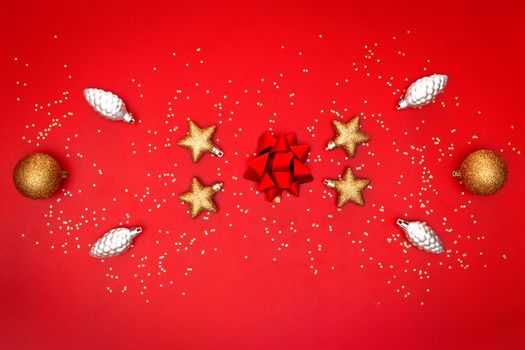 golden bow, star, bell and ball on red background for birthday, christmas or wedding ceremony