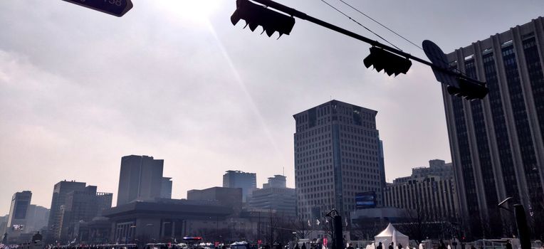 Bunch of tall buildings in the central square of Seoul, South Korea with traffic lights