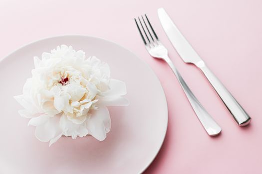 Dining plate and cutlery with peony flower as wedding decor set on pink background, top tableware for event decoration and dessert menu design