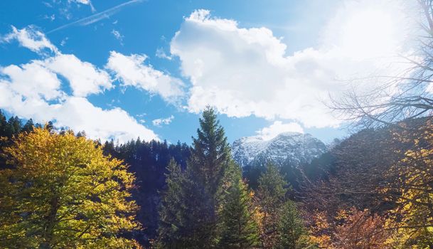 Beautiful nature of European Alps, landscape view of alpine mountains, lake and village on a sunny day, travel and destination scenery