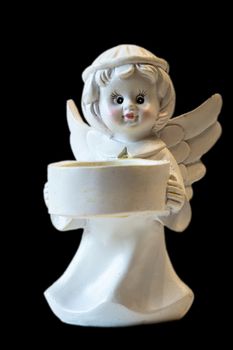White ceramic angel figurine isolated on black background. Angel figurine for concept design. The concept of love and kindness.