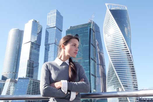 Stressed business woman in the city over skyscrapers background