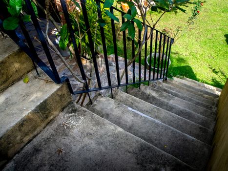 House frontyard cultured veneer stone work siding and rod iron stairs