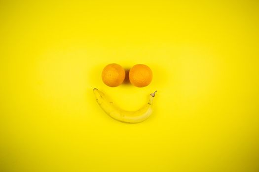 banana and oranges in the form of a smile, fruits