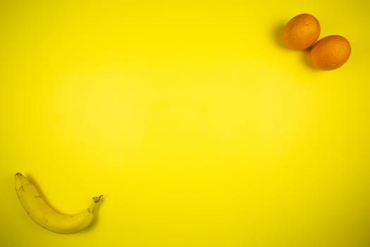 Fruit banana and orange on a yellow background, fruits