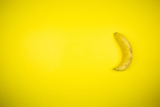 Ripe banana on a yellow background, fruits