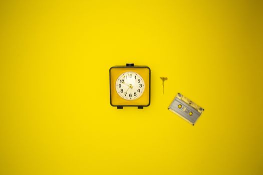 Yellow watch. Alarm clock and wild flower