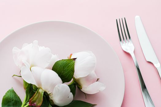 Dining plate and cutlery with peony flowers as wedding decor set on pink background, top tableware for event decoration and menu branding design