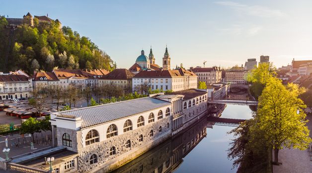 Aerial drone panoramic view of Ljubljana medieval city center, capital of Slovenia in warm afternoon sun. Empty streets during corona virus pandemic social distancing measures.