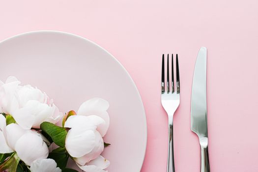 Dining plate and cutlery with peony flowers as wedding decor set on pink background, top tableware for event decoration and menu branding design