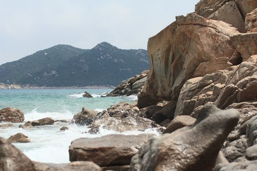 Sardinian rocky and natural beach landscape during a summer day