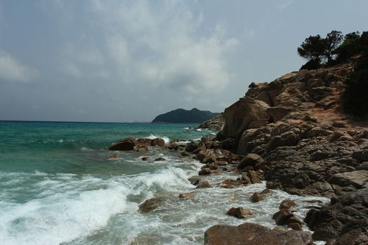 Sardinian rocky and natural beach landscape during a summer day