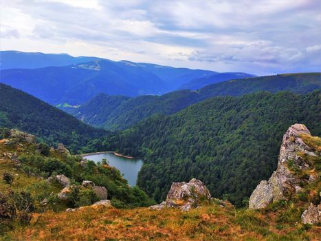 Lake Schiessrothried located in a valley between the hilly landscape of the Vosges, France
