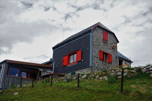 Beautiful mountain restaurant with red window frames spotted in the Vosges, France