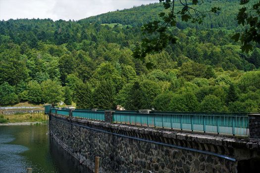 Bridge over the masonry dam at the Lac de la Lauch in the Vosges, France