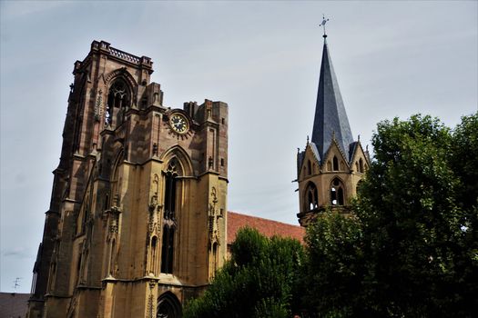 Belltower and steeple of the Assumption Church in the village Rouffach, France