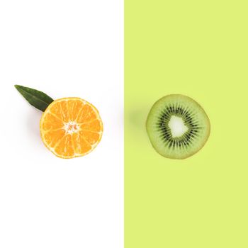 Food and fruit concept - cut of mandarine and kiwi. Top view or flat-lay. Copy space. Isolated on white with clipping path.