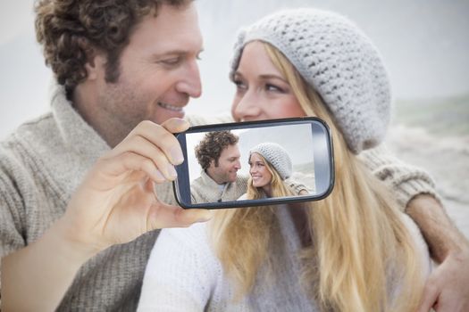 Composite of Couple taking selfie on smartphone