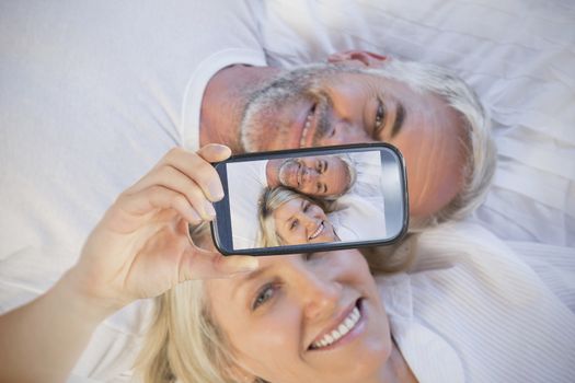 Composite of Couple taking selfie on smartphone