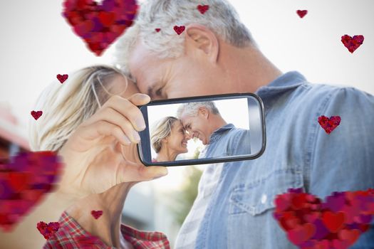 Composite of Couple taking Valentines selfie