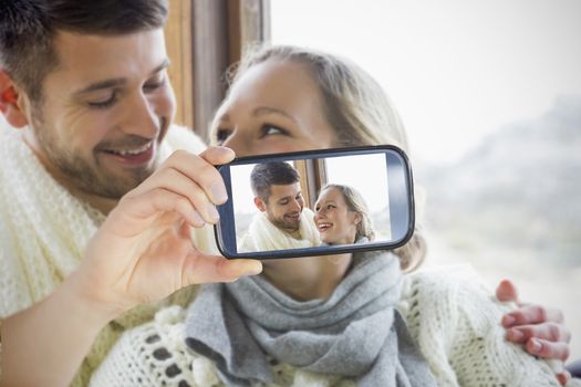 Composite of Couple taking selfie on smartphone