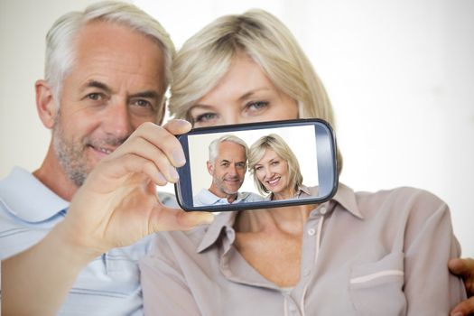 Composite of Couple taking selfie on smartphone