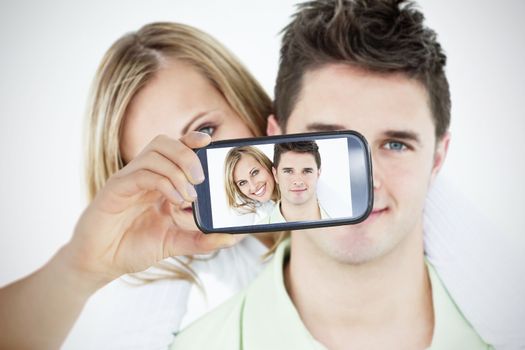 Composite of Couple taking selfie on smartphone