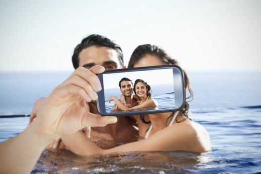 Composite of Couple taking selfie on smartphone