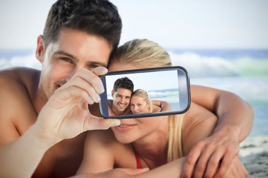 Composite of Couple taking selfie on smartphone
