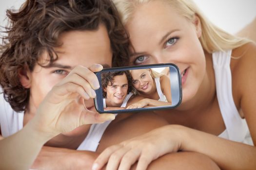 Composite of Couple taking selfie on smartphone