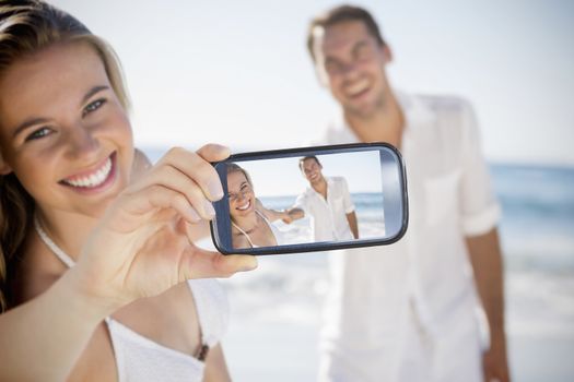 Composite of Couple taking selfie on smartphone