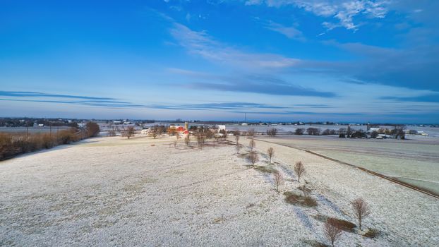 Aerial of fresh early snow fall on countryside on a clear morning