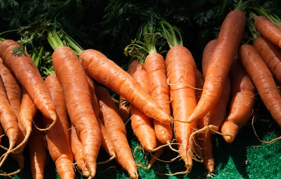 Fresh carrots for sale on a market stall