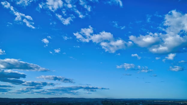 Blue sky and multiple clouds background