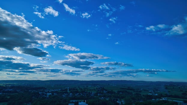 Blue sky and multiple clouds background showing a horizon