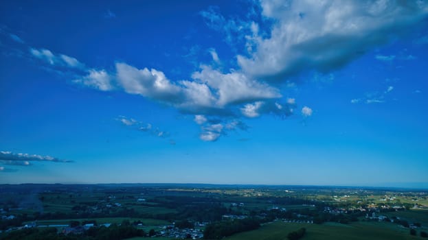 Blue sky and multiple clouds background showing a horizon
