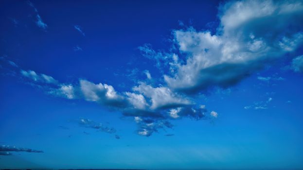 Blue sky and multiple clouds background
