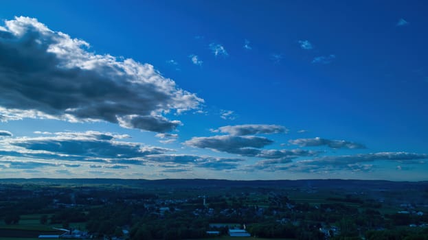 Blue sky and multiple clouds background showing a horizon