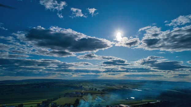 Blue sky and multiple clouds background showing a horizon