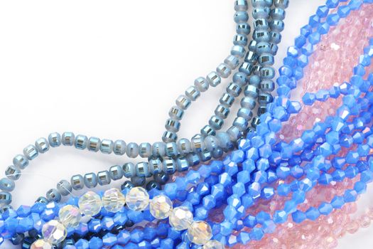 Mix of color faceted glass sparkle beads. Materials for creative work on white background.