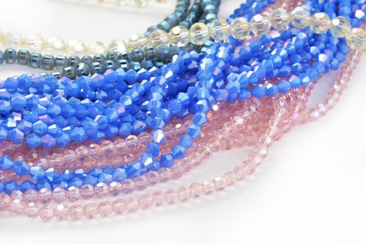 Mix of color faceted glass sparkle beads. Materials for creative work on white background.