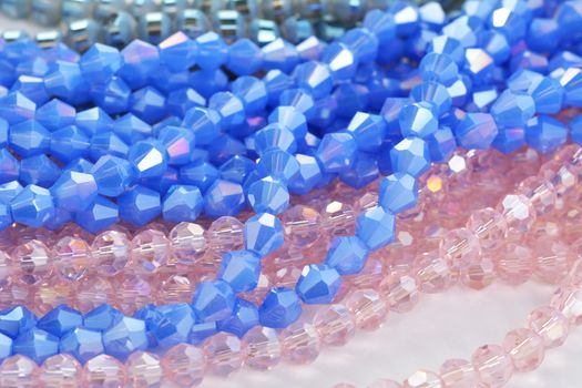 Mix of color faceted glass sparkle beads. Materials for creative work on white background.