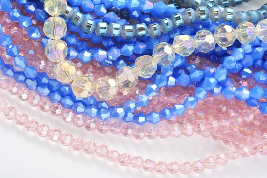 Mix of color faceted glass sparkle beads. Materials for creative work on white background.