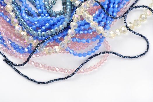 Mix of color faceted glass sparkle beads. Materials for creative work on white background.