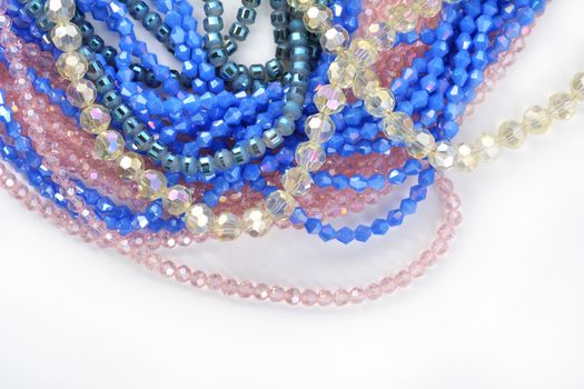 Mix of color faceted glass sparkle beads. Materials for creative work on white background.