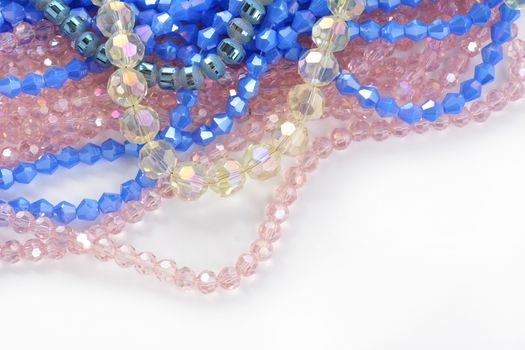 Mix of color faceted glass sparkle beads. Materials for creative work on white background.