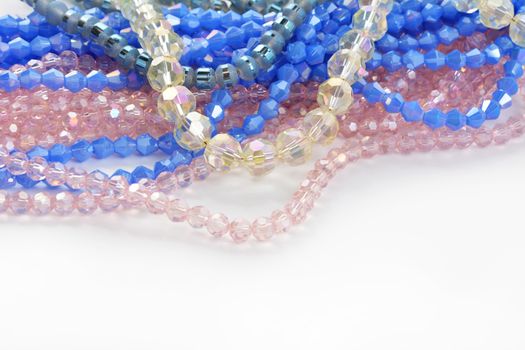 Mix of color faceted glass sparkle beads. Materials for creative work on white background.